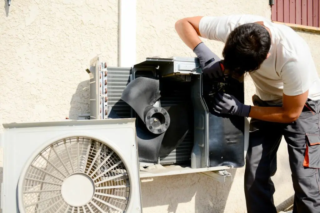 A Man With Gloves Checking on a Machine